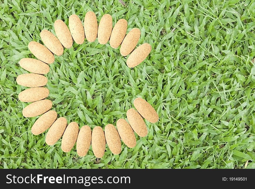 Vitamin c as green grass background