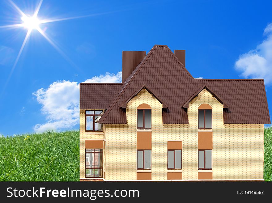 New cottage on a slope of mountain against the bright sun. New cottage on a slope of mountain against the bright sun