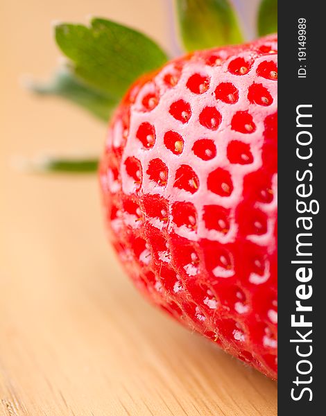 Closeup of ripe strawberry on wooden background. Closeup of ripe strawberry on wooden background