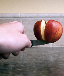 Apple Being Cut In Half Stock Images