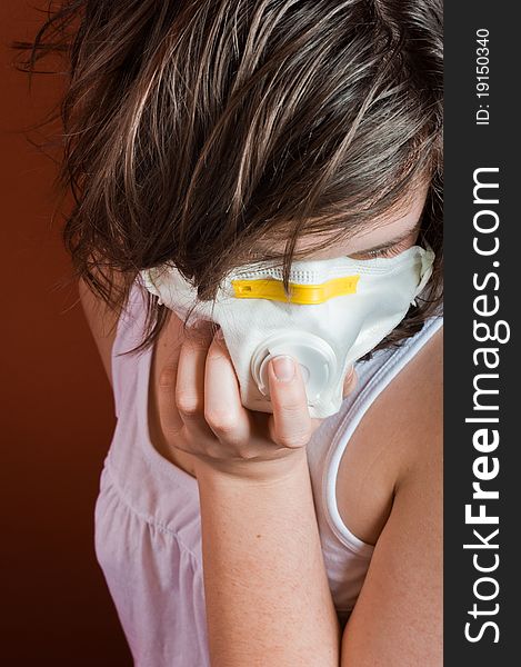 Girl wearing protective mask against red background