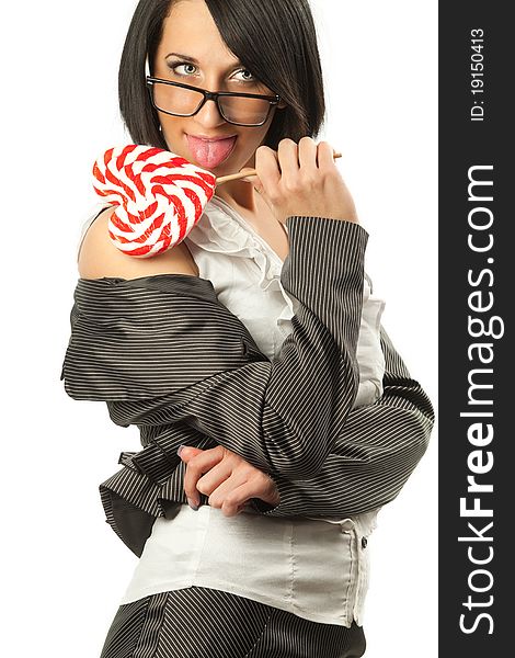 Young sexy woman in business suit licking heart shaped lollipop. Young sexy woman in business suit licking heart shaped lollipop.