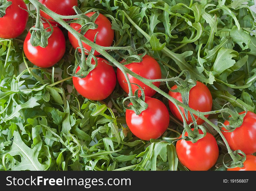Fresh rucola salad and ripe cherry tomatoes. Fresh rucola salad and ripe cherry tomatoes.