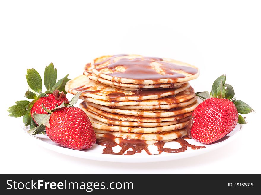 Pancakes stak topped with chocolate souce and strawberies. Pancakes stak topped with chocolate souce and strawberies