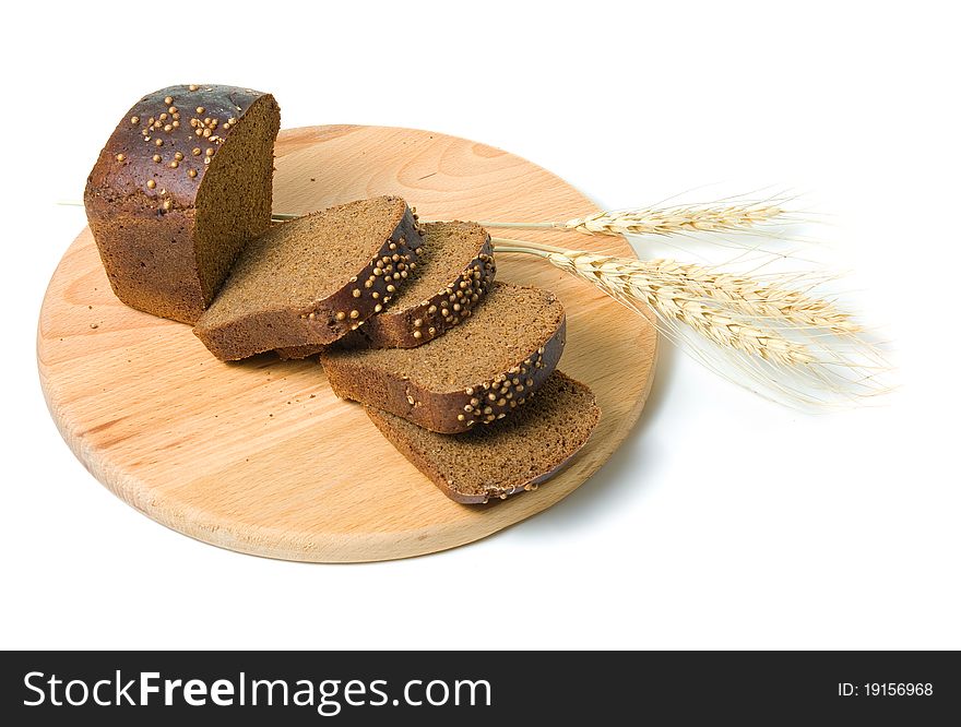 Slices of bread and shafts of wheat on a white background