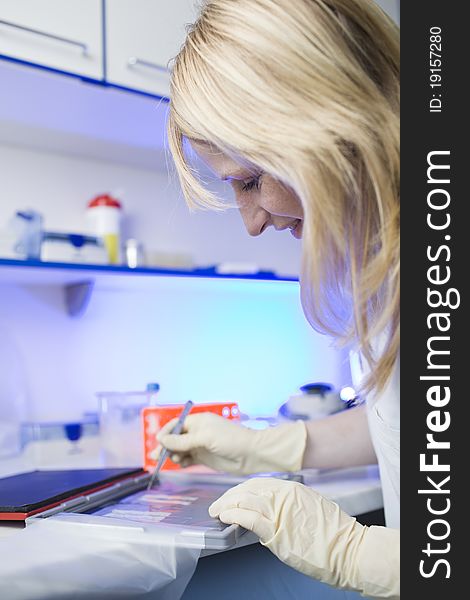 Portrait of a female researcher doing research in a lab (color toned image; shallow DOF)