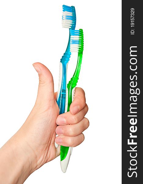 Two isolated tooth brushes holding by hand
