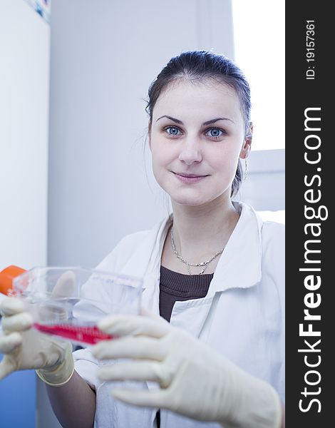 Portrait of a female researcher doing research in a lab (color toned image; shallow DOF). Portrait of a female researcher doing research in a lab (color toned image; shallow DOF)