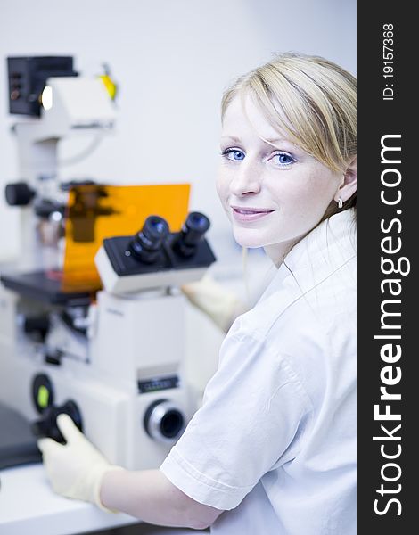 Portrait of a female researcher doing research in a lab (color toned image; shallow DOF). Portrait of a female researcher doing research in a lab (color toned image; shallow DOF)