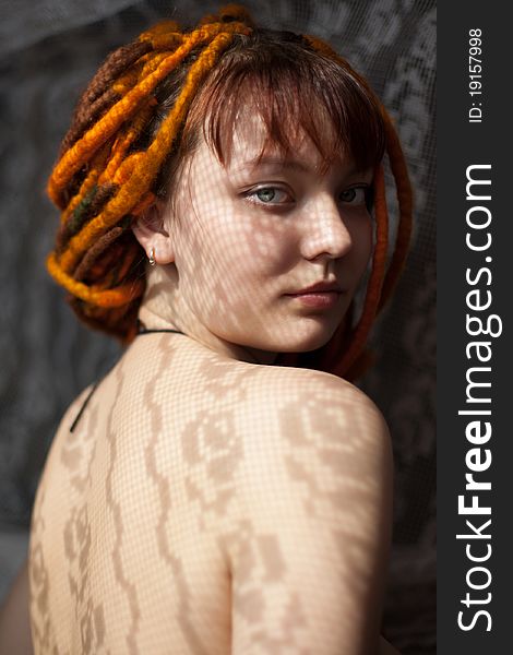 Art portrait of a girl with dreadlocks