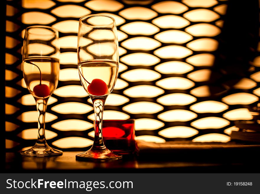 Glasses with champagne and cherry in the club