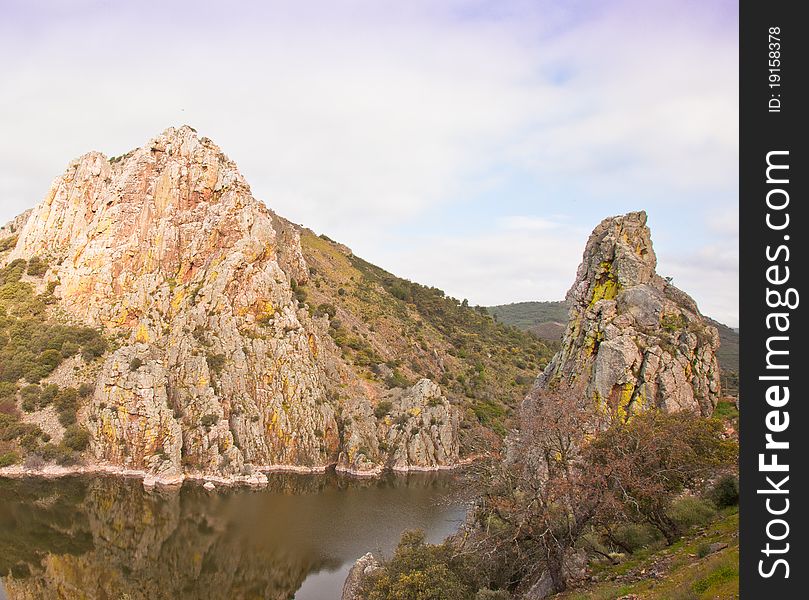 The MonfragÃ¼e National Park in Extremadura, western central Spain, shows many wild landscapes with abrupt cliffs, home to vultures and the Black Stork. The MonfragÃ¼e National Park in Extremadura, western central Spain, shows many wild landscapes with abrupt cliffs, home to vultures and the Black Stork.