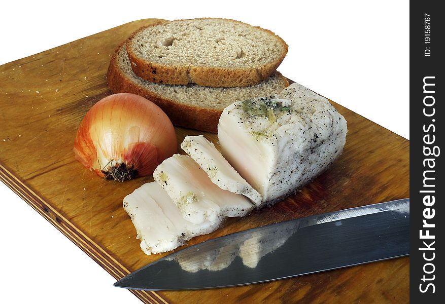 Bacon, onion, chunks of bread and a knife on a cutting board, white background