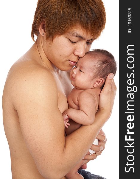 A oriental father holding on to his new baby showing his love and affection on his face. A oriental father holding on to his new baby showing his love and affection on his face.