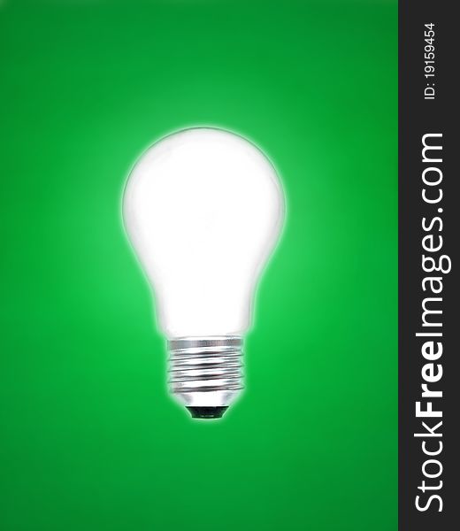 A light bulb isolated against a green background