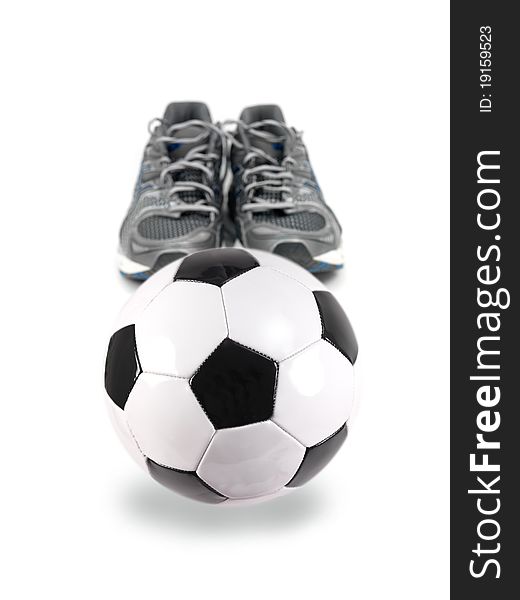 A soccer ball and joggers isolated against a white background