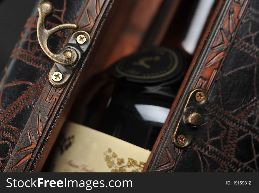 Cognac bottle in wooden case background