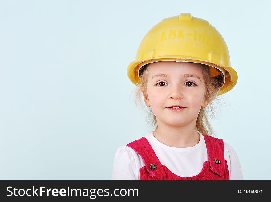 Lovely blond little girl with yellow helmet. Lovely blond little girl with yellow helmet
