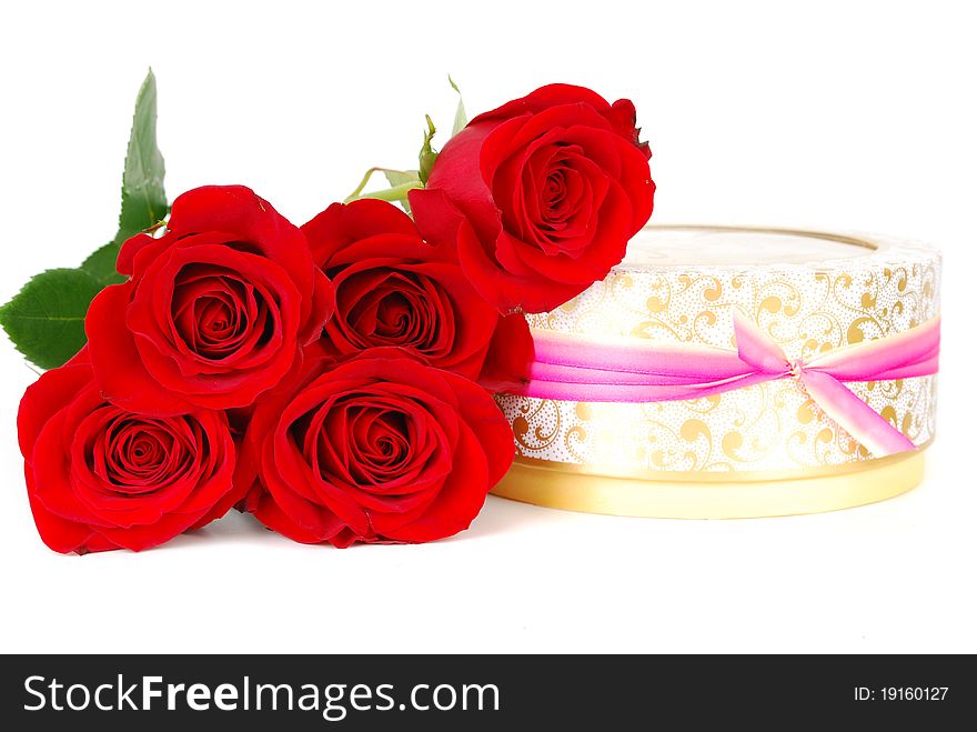 Beautiful red roses and present round boxes with candle with ribbon isolated on the white. Beautiful red roses and present round boxes with candle with ribbon isolated on the white.