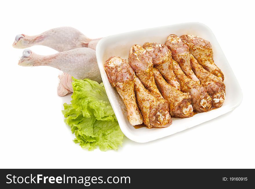 Marinated chicken and fresh chicken on a white background