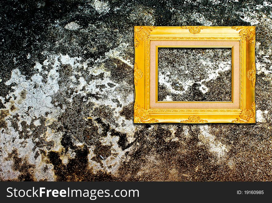 Rough wall with vintage gold frame