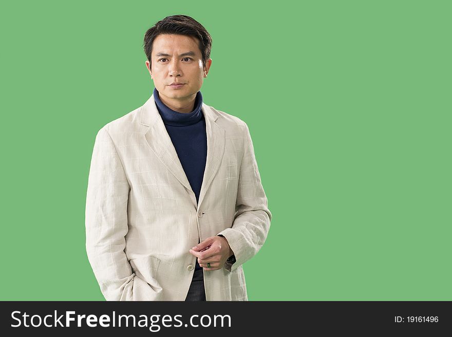 Studio shot of a Chinese man with green back. Studio shot of a Chinese man with green back