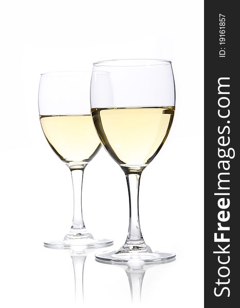 Two glasses of white wine on a white background. Two glasses of white wine on a white background