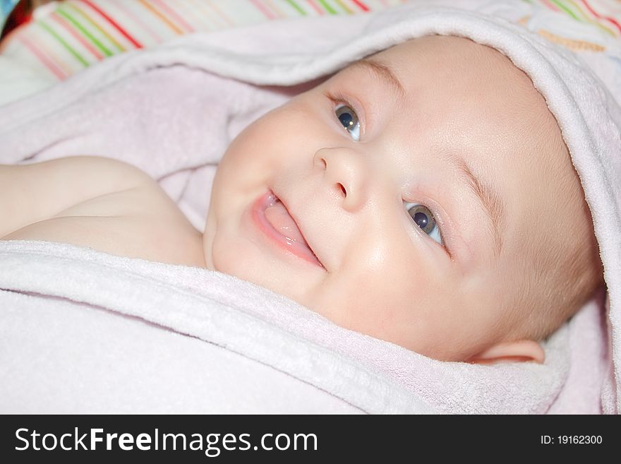 The little boy in a towel on a bed. The little boy in a towel on a bed