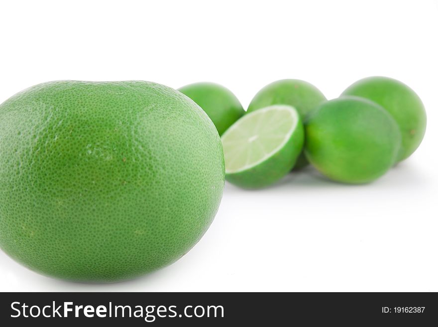 Green grapefruit with limes isolated on white