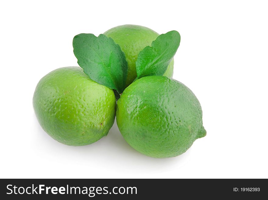 Three limes with leaves isolated on white