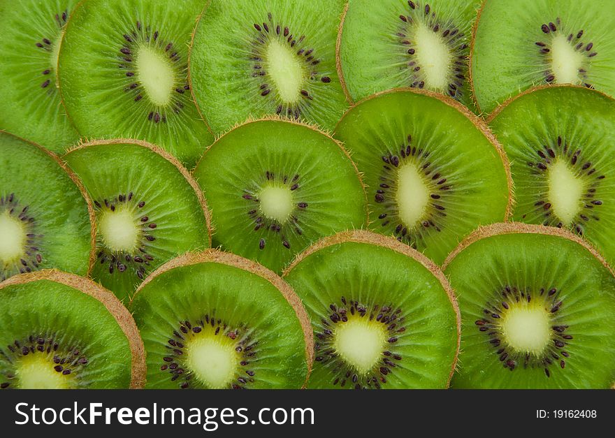 Close-up of kiwi slices forming background