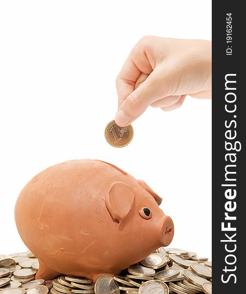 Piggy bank and coins on white background. Piggy bank and coins on white background
