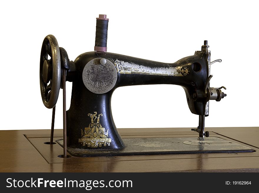 Antique sewing machine. Taken on white background. Antique sewing machine. Taken on white background.