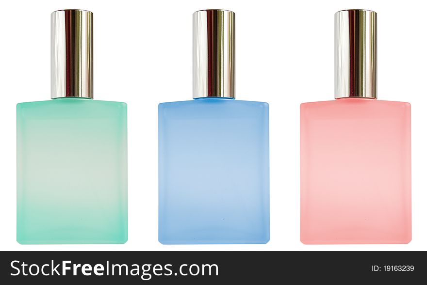 Colored perfume bottles isolated on white