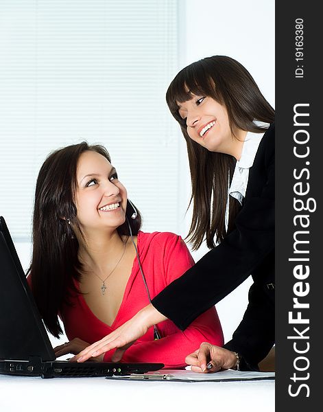 Two beautiful girls working in the office