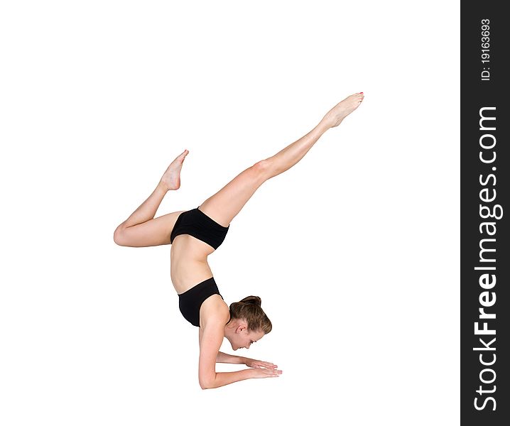 Beautiful young woman balancing on her forearms pointing her feet in the air. Beautiful young woman balancing on her forearms pointing her feet in the air