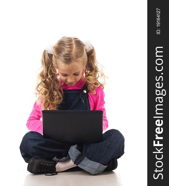 Young girl typing something on her own laptop. Young girl typing something on her own laptop