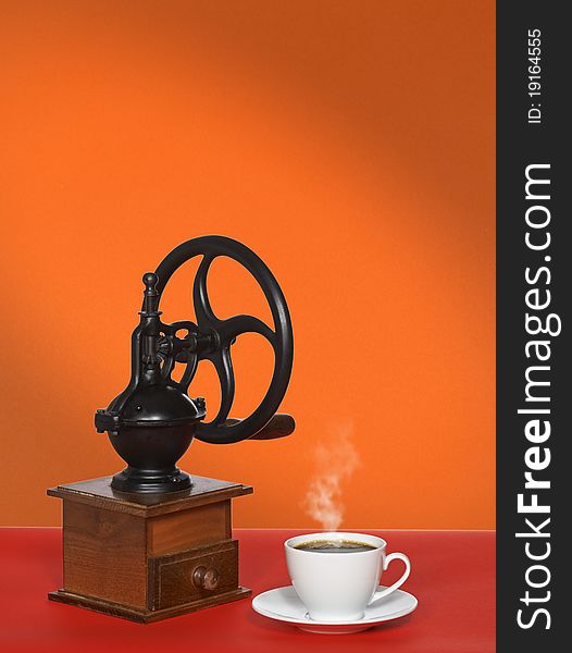 Coffee grinder, a cup of coffee on the table