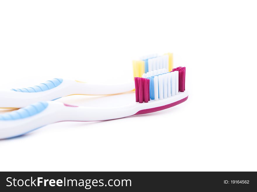 Red and yellow toothbrushes isolated on white background