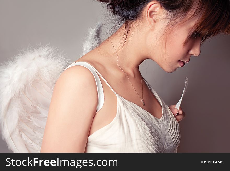 Girl wearing a white top with wings. Girl wearing a white top with wings.