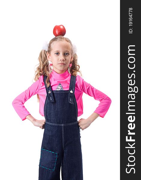 Portrait of young girl with red apple on head