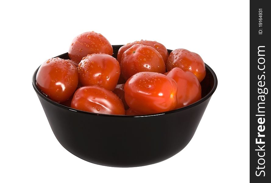 Red cherry tomatoes in the black bowl isolated on white