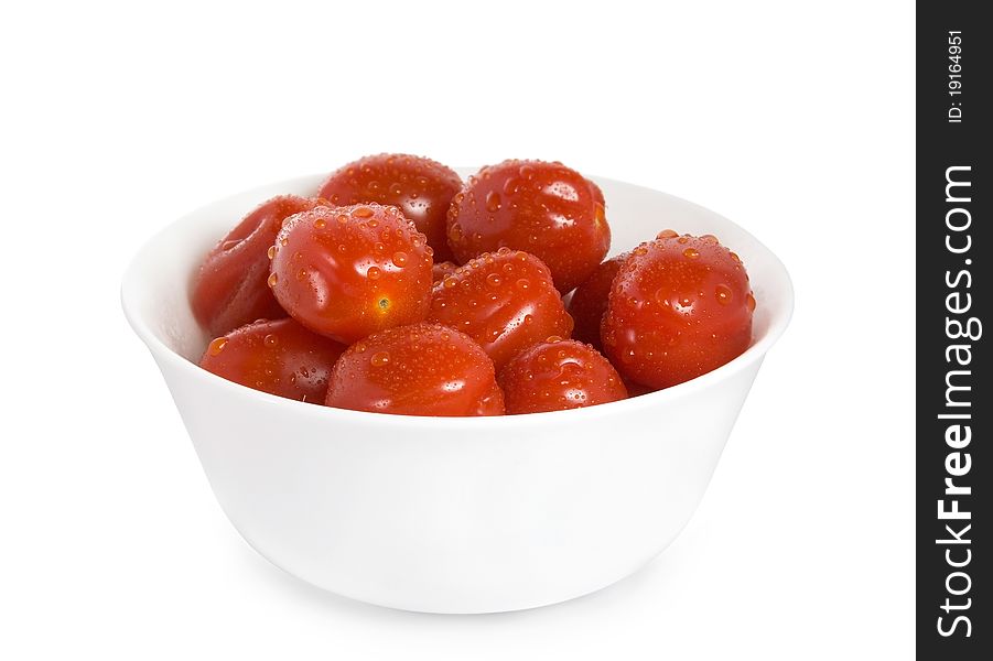 Red cherry tomatoes in the white bowl isolated on white