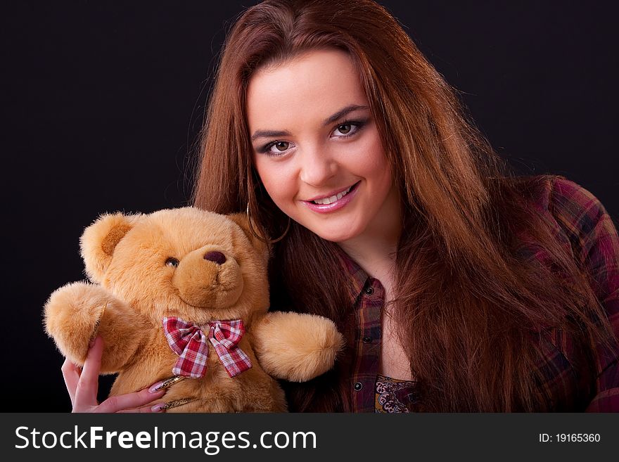 Beautiful longhair girl is holding the teddy bear. Beautiful longhair girl is holding the teddy bear