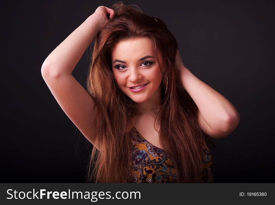 Beautiful young longhair brunette in a romantic pose. Beautiful young longhair brunette in a romantic pose