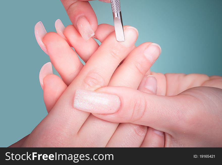 Manicure process with professional tools on female hand