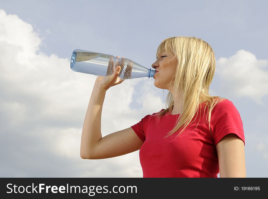 Young woman drinking water from a bottle