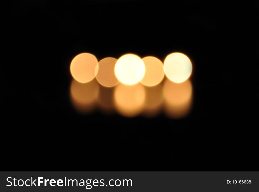 Candles' fire and its reflection without sharpness. Black background. Candles' fire and its reflection without sharpness. Black background.