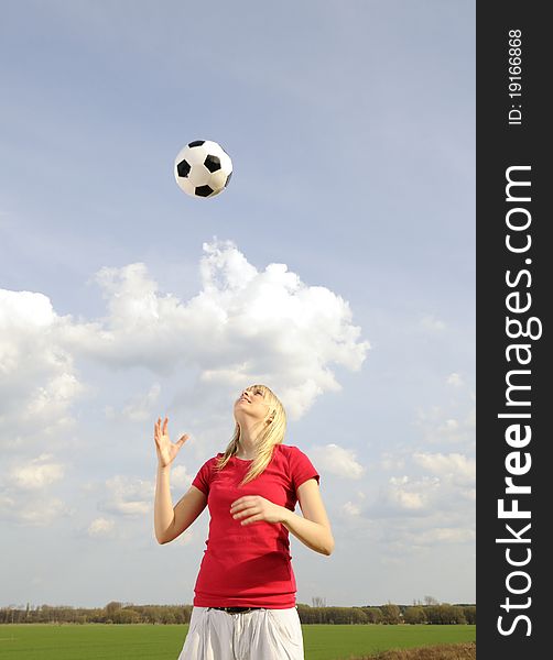 Beautiful young blond woman playing with soccer ball. Beautiful young blond woman playing with soccer ball