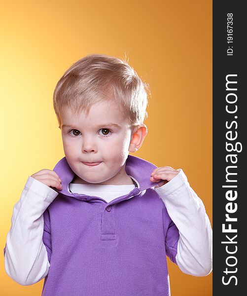 Cute blonde boy posing looking at camera